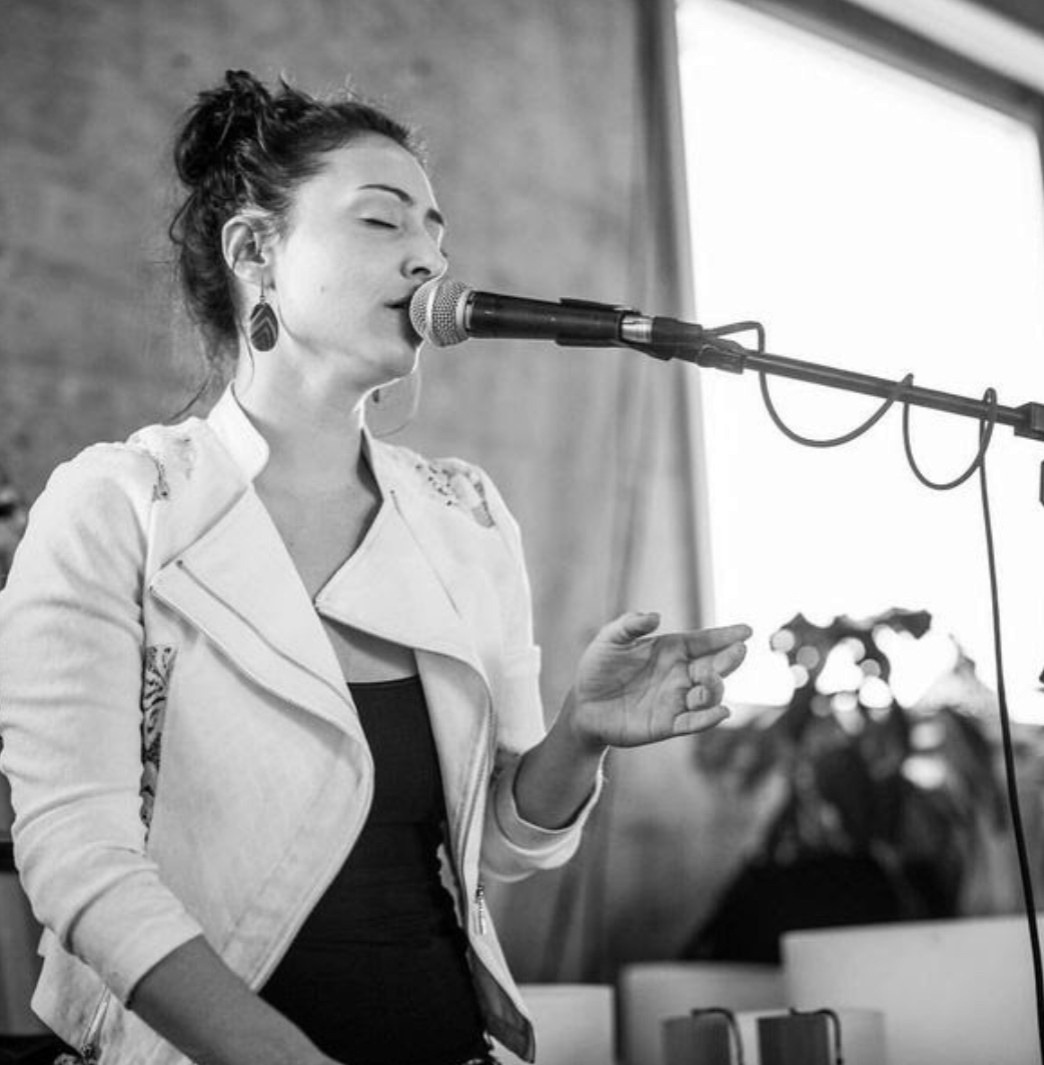 Larisa singing with her eyes closed